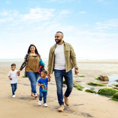 a family embarking on a coastal walk