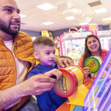 a family playing in the amusement arcades