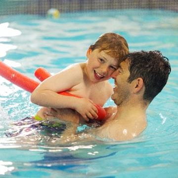 A family playing in the swimming pool