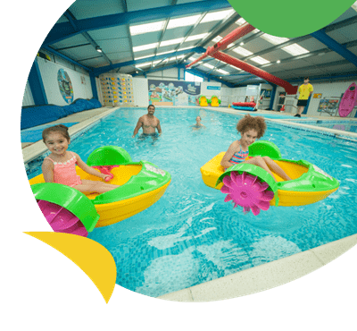 Kids on Aqua Paddlers in the indoor swimming pool at Sandylands Holiday Park