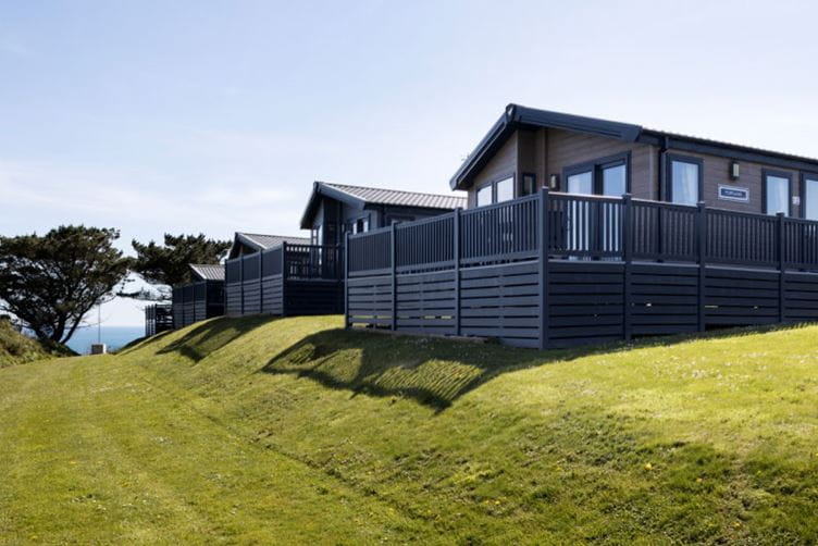 The exterior of a Sea Acres Lodge surrounded by grass and trees