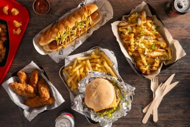 A burger, fries and other food laid out on a table