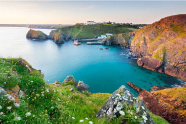 beautiful landscape picture of Mullion bay in the sunset