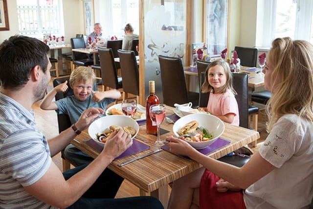 family enjoying a meal in the restaurant