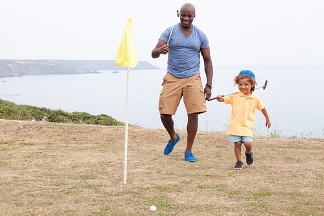father and daughter playing golf