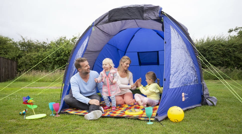A family relaxing in their tent