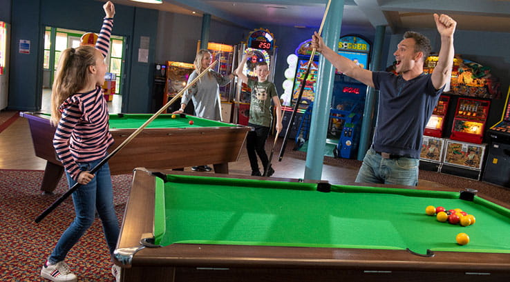 People enjoying games of pool in the arcade at Skipsea Sands Holiday Park