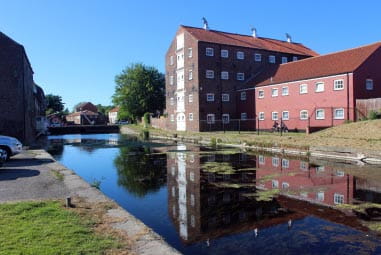 Brick housing development alongside a canal