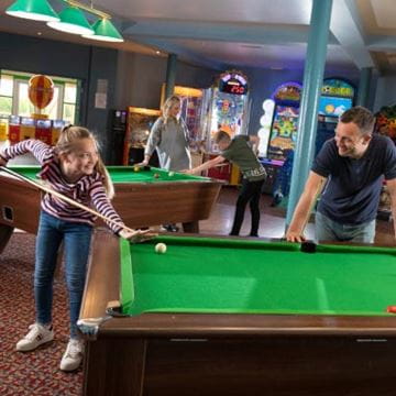 People playing pool in a sports hall