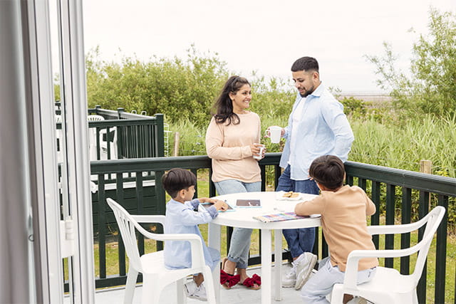 A family enjoying their holiday caravan veranda at Southerness Holiday Park