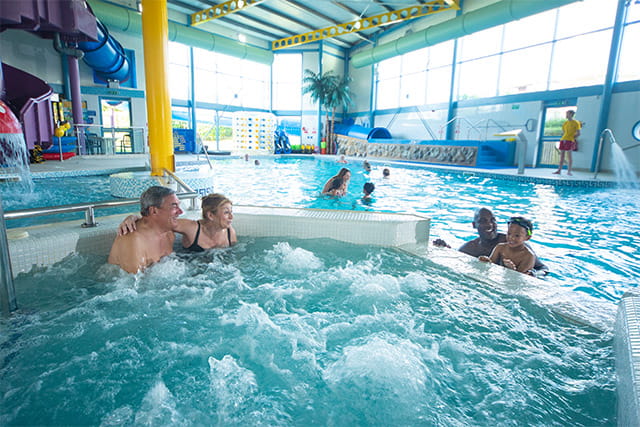 People having fun in the indoor swimming pool at Southerness Holiday Park