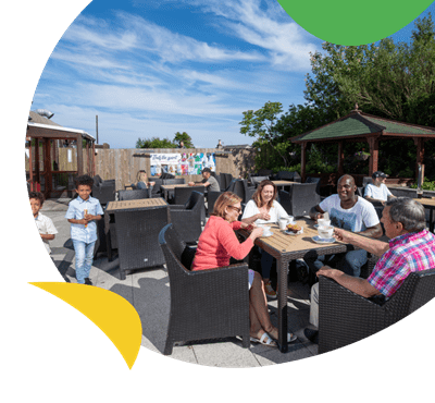 A family having a meal in the beer garden at Southerness Holiday Park