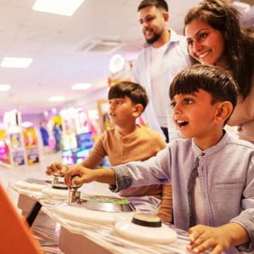 Family playing an arcade game