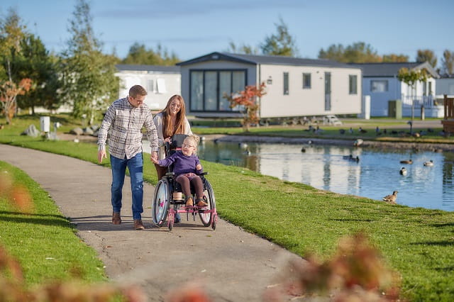A mother and father with a daughter in a wheelchair at Southview Holiday Park