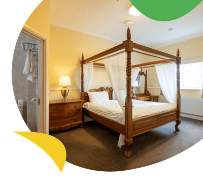 Hotel bedroom with four poster bed at Southview Holiday Park