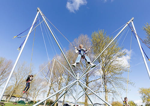 Child in the air on a bungee trampoline