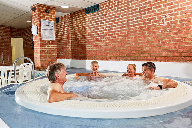 Two couples relaxing in the jacuzzi