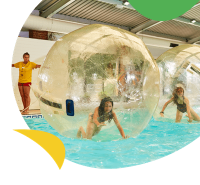 Kids in water walkers in the indoor swimming pool at St Margaret's Bay Holiday Park