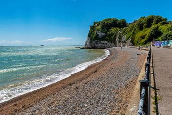 Coastline with blue sea and cliffs in the distance