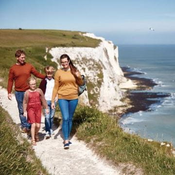 Family taking a coastal walk on a white cliff