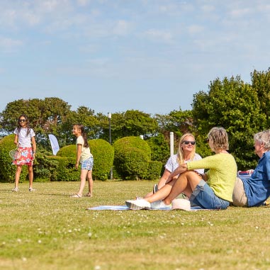 People lounging in a park on a sunny day