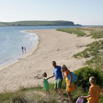 A family walking to the beach