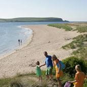 A family walking to the beach