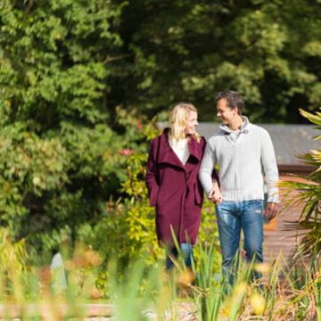 a couple strolling through the countryside 