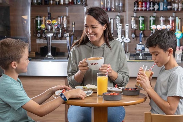 mother and two sons eating a meal in a restaurant