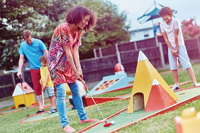 family playing crazy golf