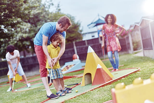 Family enjoying mini golf at Summerfields Holiday Park