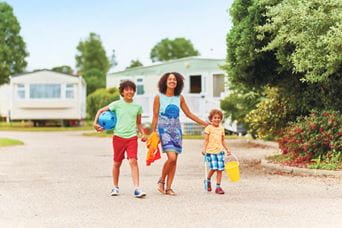 a family walking through the holiday park