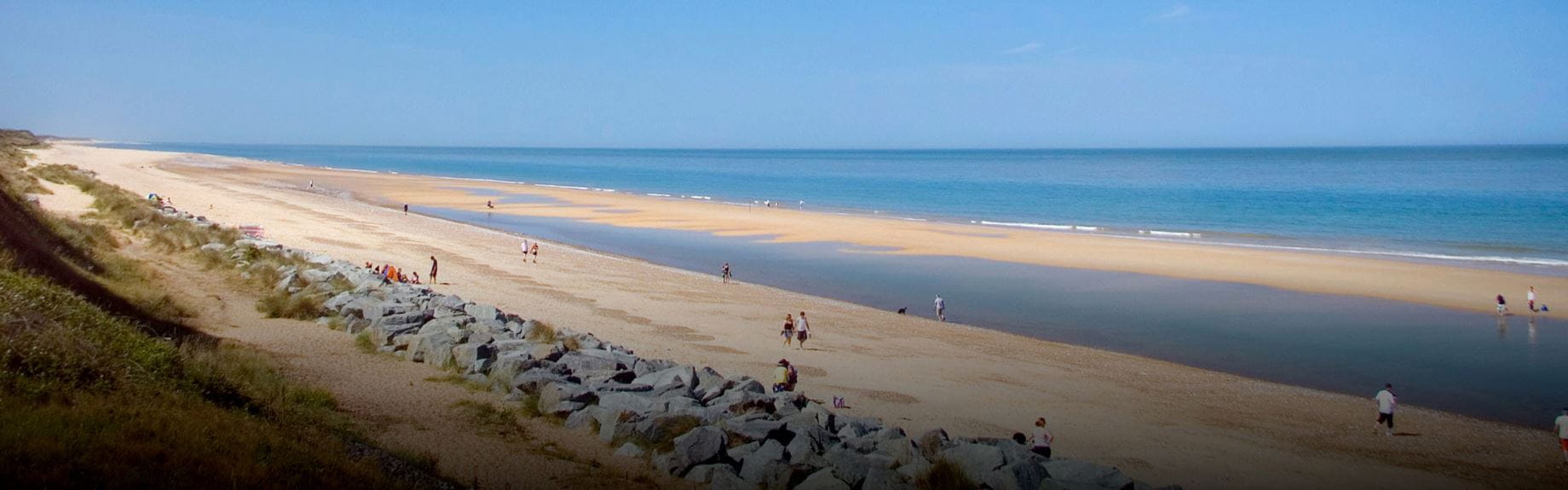 a long sandy beach on a summer day