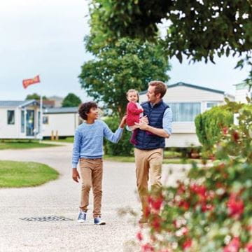 a family walking through the holiday park