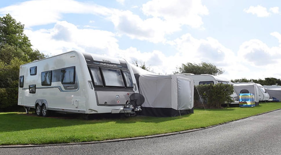 Touring caravans and awnings pitched up on the grass