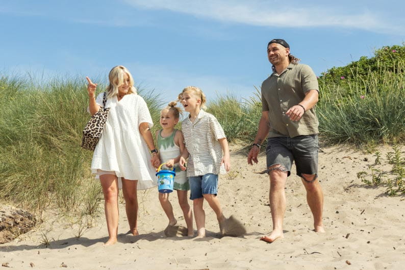 A family walking on a sandy beach