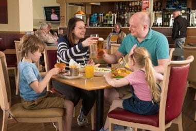 a family enjoying a meal at a restaurant