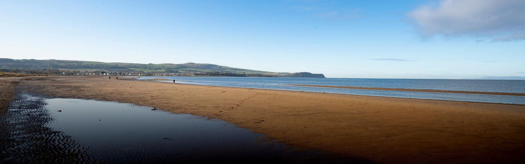 a panoramic landscape of sandy beach and blue sea