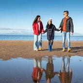 a family going on a coastal walk