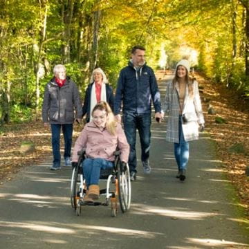 A family taking a walk through the woods