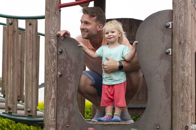 father and daughter on the outdoor play facilities