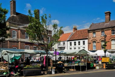 an outdoor market in a quaint small town