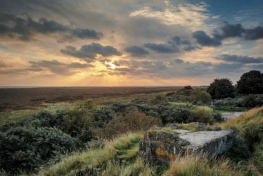 Green rolling moors at sunset