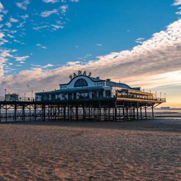 a seaside peer on a beach