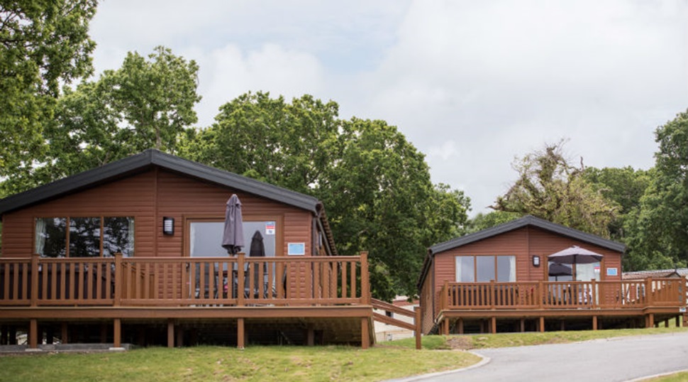 Wooden lodges with verandas at Thorness Bay Holiday Park