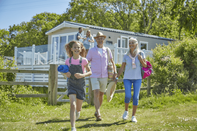 Family outside park home in Thorness Bay