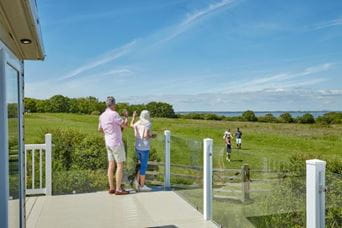 Couple stood on veranda at Parkdean Resorts