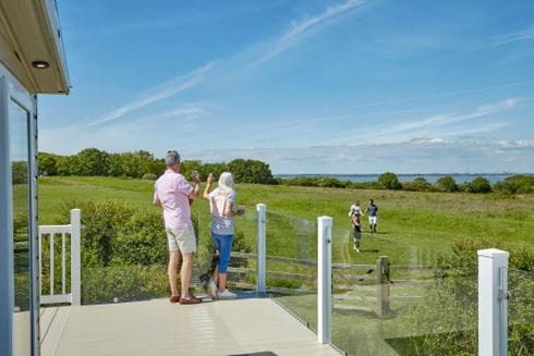 Couple stood on veranda at Parkdean Resorts