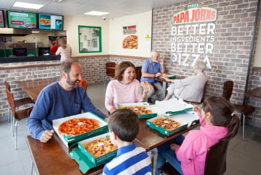 A family enjoying pizzas at papa johns