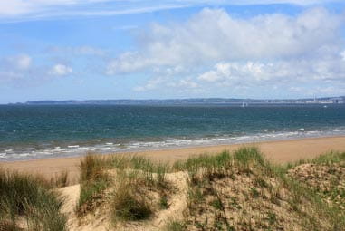 rolling waves and a sandy beach on a sunny day